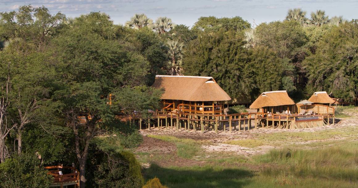 Aerial view of Camp Okavango thatched buildings on Nxaragha Island