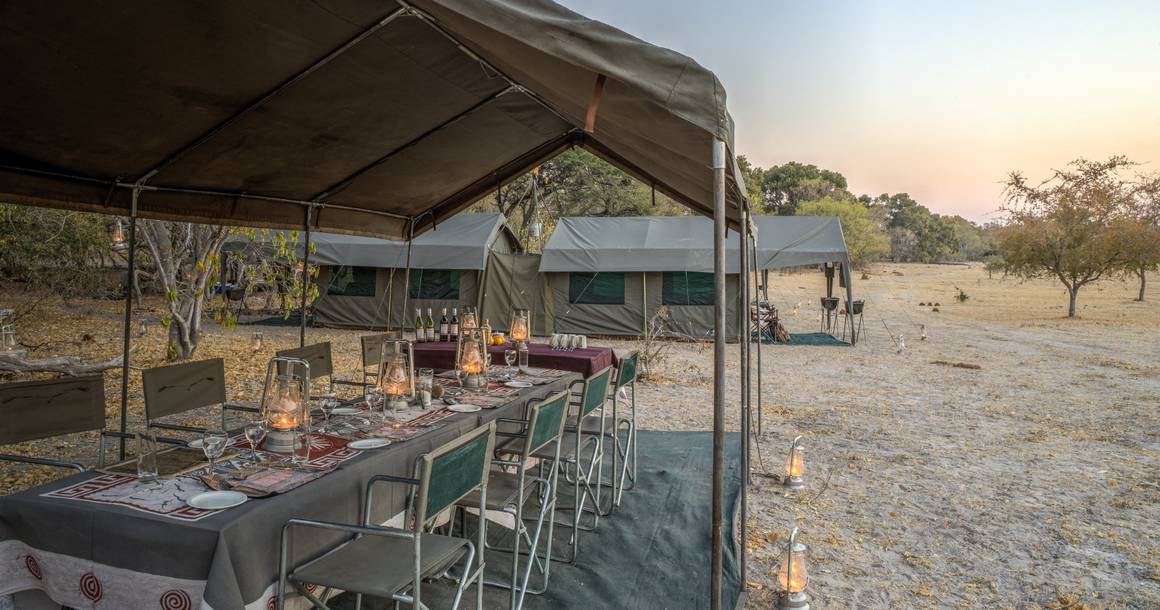Letaka camp dining setup with sleeping tents in the background