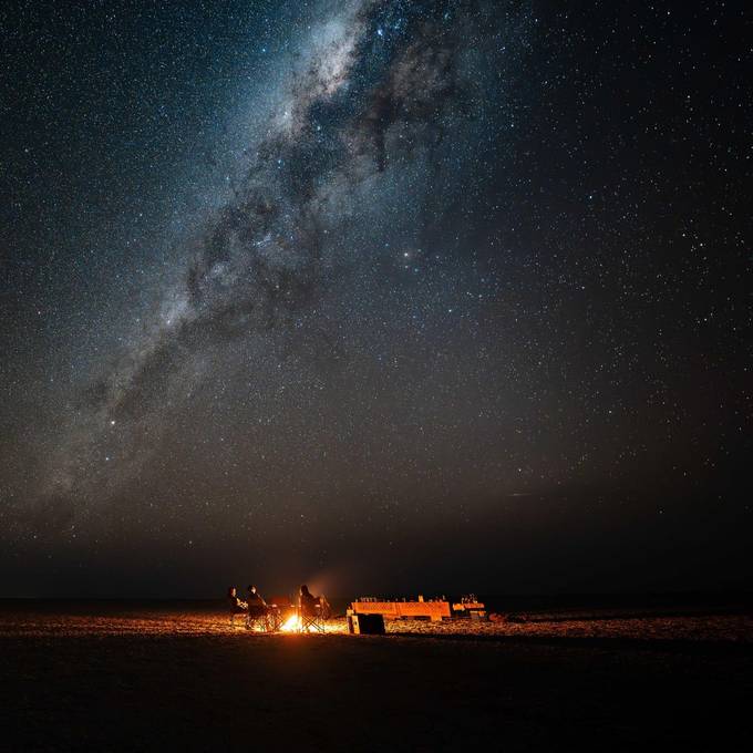 Milky Way over a campfire on the Makgadikgadi salt pans