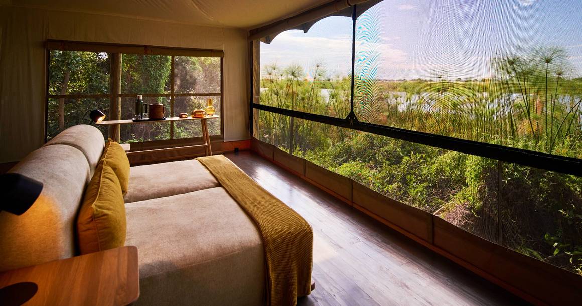 Xugana Island Lodge tented room with lagoon and papyrus view
